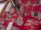 A repairman solders a printed circuit board of an electronic device in red color close-up. Repair and soldering of chips with a