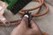 A repairman or technician uses a brush to scrub a dirty derailleur pulley cog of a mountain bike. Maintenance service