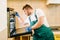 Repairman in uniform checks the oven, technician