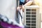 Repairman washing dirty compartments air conditioner, Male technician cleaning air conditioner indoors, Maintenance and repairing