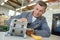 Repairman working on cylindrical electrical component