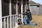 Repairman works on door of back porch