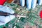 Repairmans hands repairing printed circuit board