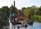 Repairs to the riverbank of the River Great Ouse at St Neots Cambridgeshire Equipment on floating pontoon being used to drive in