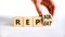 Repeat and repair symbol. Businessman turns a wooden cube and changes the word repeat to repair. Beautiful white table, white