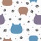 Repeated feline heads, paw prints and round dots. Cute seamless pattern for children.