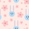 Repeated flowers and rabbit heads. Cute seamless pattern for children.