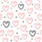 Repeated round dots and hearts drawn by hand with a rough brush. Cute watercolour seamless pattern.