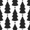Repeated silhouettes of Christmas trees with stars. New year seamless pattern.
