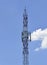 Repeater telecommunication tower with blue sky on background