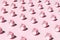 Repetitive pink alarm clocks on pink background