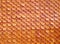 repetitive wave pattern or fish scale striped of orange roof clay tile of temple or thai antique house