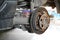 Replacement of car brake pads in garage. Worn brake pads ,selective focus