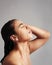 Replenish your skin with a lovely shower. Studio shot of a young woman enjoying a shower against a gray background.