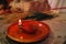 Replica of ancient Roman oil lamp with lighted candle on thanksgiving table