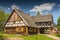 Replica of early 20th century hut with arcade extension, Olsztynek, Poland.