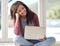 Replying to some emails. Portrait of a young woman using her laptop while sitting on the floor.