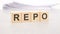 repo word written on wood cubes with white background
