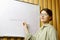 Report on the topic of generative artificial intelligence, a young woman near a flipchart