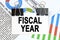 Among the reporting charts and diagrams is a plate with the inscription - FISCAL YEAR
