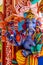 Representation of Hindu gods and tourists climbing a colorful stairs leading to the Batu Caves