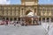 Republic Square with a classic carousel permanently installed in its center with children mounted on it and surrounded