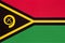 Republic Vanuatu national fabric flag, textile background. Symbol of world oceania country