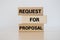 Request for proposal written on wood block on white background