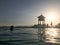 Rescue booth, tower, rescue post on the edge of the water of a luxurious infinity pool merging with the horizon against the backdr