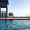 Rescue booth, tower, rescue post on the edge of the water of a luxurious infinity pool merging with the horizon against the backdr