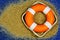 Rescue circle in the sand, help is on the sea. Rescue equipment on the water in danger of drowning-floating float in the form of a