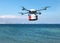 Rescue drone with lifebuoy flying over the ocean.