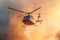 A rescue helicopter extinguishes a forest fire by dropping a large amount of water on a burning coniferous forest
