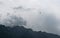 Rescue helicopter fliying over mountains into a dark and stormy ominous sky