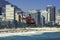 Rescue helicopter flying over crowded Copacabana Beach during hot summer day in Rio de Janeiro, Brazil.