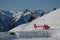 Rescue helicopter parked on a provisional helipad in the mountains ready for action. Red rescue helicopter outdoors