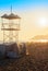 Rescue lifeguard tower by sea ocean sandy beach at sunset