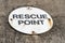 Rescue point sign attached to a sea wall in a coastal town in the UK