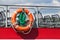 A rescue ring on the cruise ship`s railing. Rescue the drowning. Safety equipment.