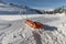 Rescue sled in the snow. Transport sleigh for injured skiers. Prepare ski slope, Alpe di Lusia, Italy