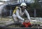 Rescue team training of chemical decontamination: rescuer in a protective ensemble turning a valve of a fire hydrant