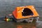 Rescue worker showing life raft in harbor Urk, the Netherlands