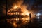 Rescuer battles smoldering embers in burnt out house, water providing essential aid