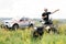 The rescuer, a beautiful athletic physique, rides an ATV in the middle of the field