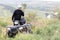 The rescuer, a beautiful athletic physique, rides an ATV in the middle of the field