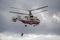 The rescuer descends from the fire-rescue helicopter Ka-32A EMERCOM of Russia at the airfield Miachkovo