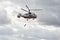 The rescuer descends from the fire-rescue helicopter Ka-32A EMERCOM of Russia at the airfield Miachkovo