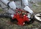 Rescuer hands in protective gloves turning a valve of a fire hydrant to water plant territory