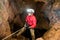 Rescuers or climber descends in a cave fast rope