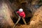 Rescuers or climber descends in a cave fast rope